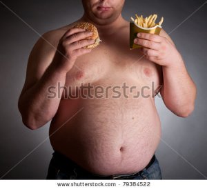 fat-man-with-hamburger-and-chips-on-dark-background-79384522